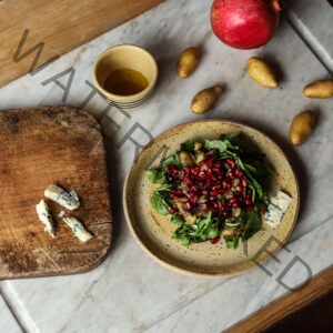 Wild Arugula, Potato, And Pomegranate Salad with a Lemon Blossom Honey Vinaigrette and Blue Cheese